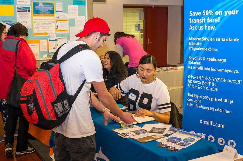 Picture of student talking to community partner at table