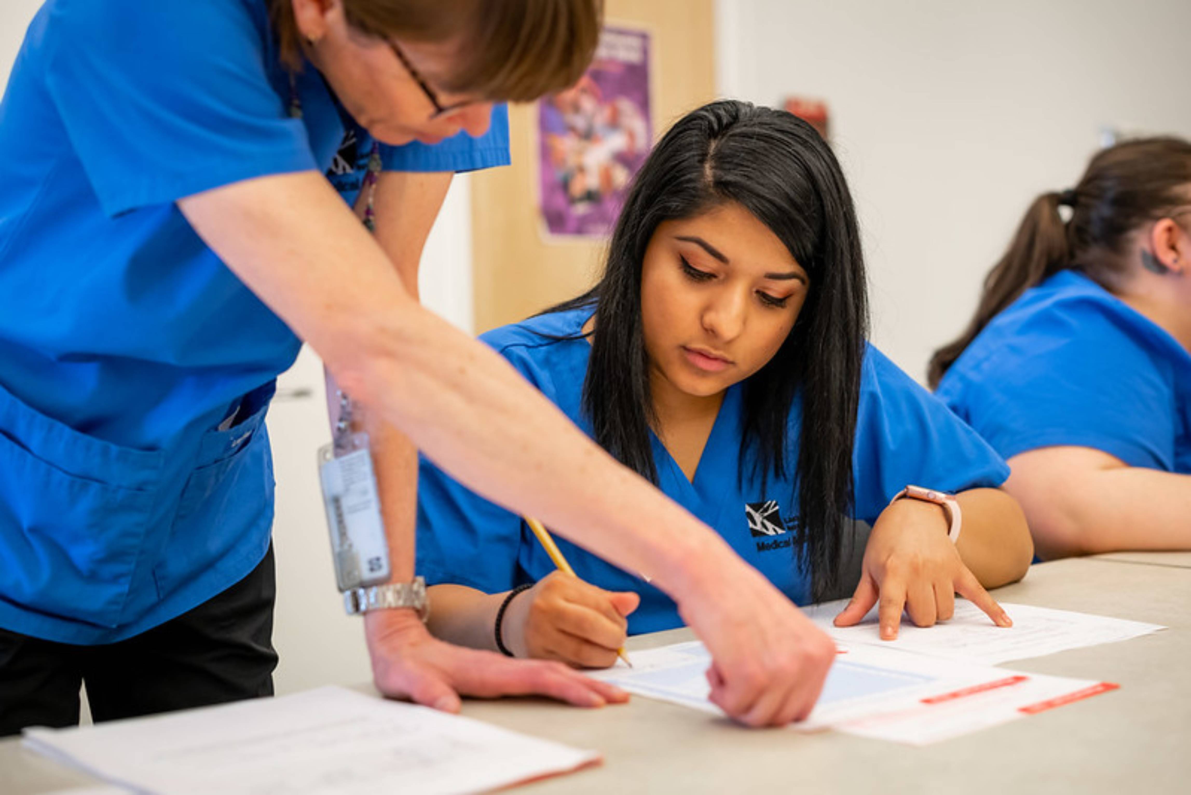 Nursing students studying in classroom